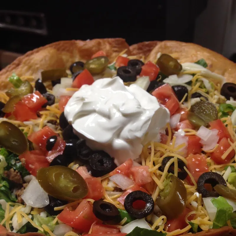 Loaded nachos with sour cream and olives