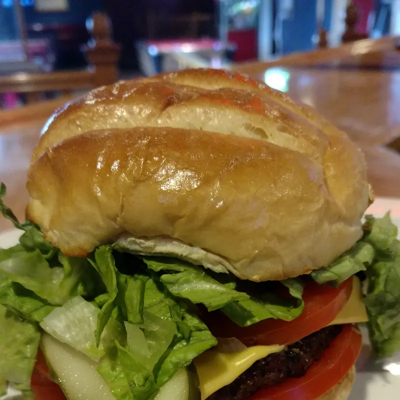 Tall stacked cheeseburger with lettuce and tomato