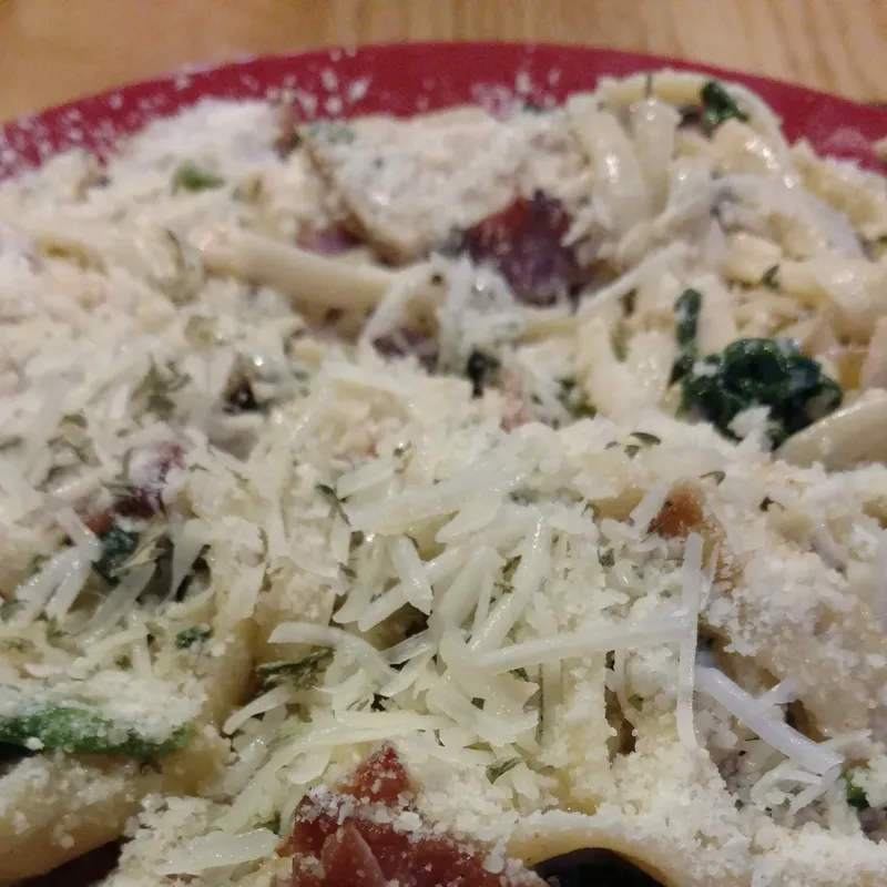 Creamy alfredo pasta topped with bacon