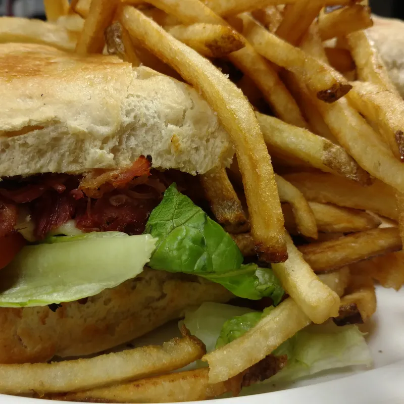 Grinder with fries and a pickle spear