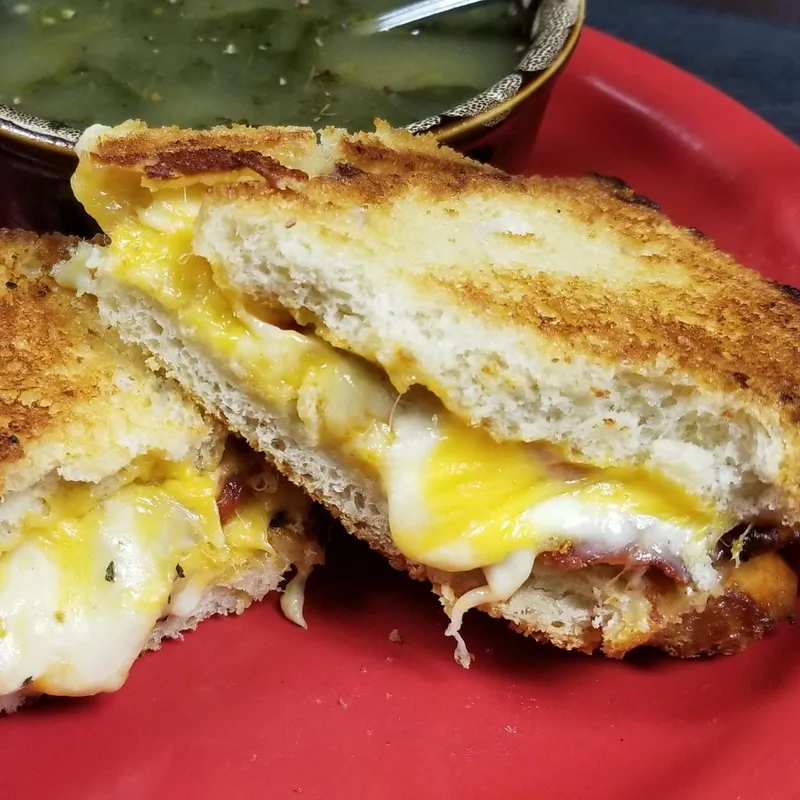Grilled sub sandwich cut in half with soup