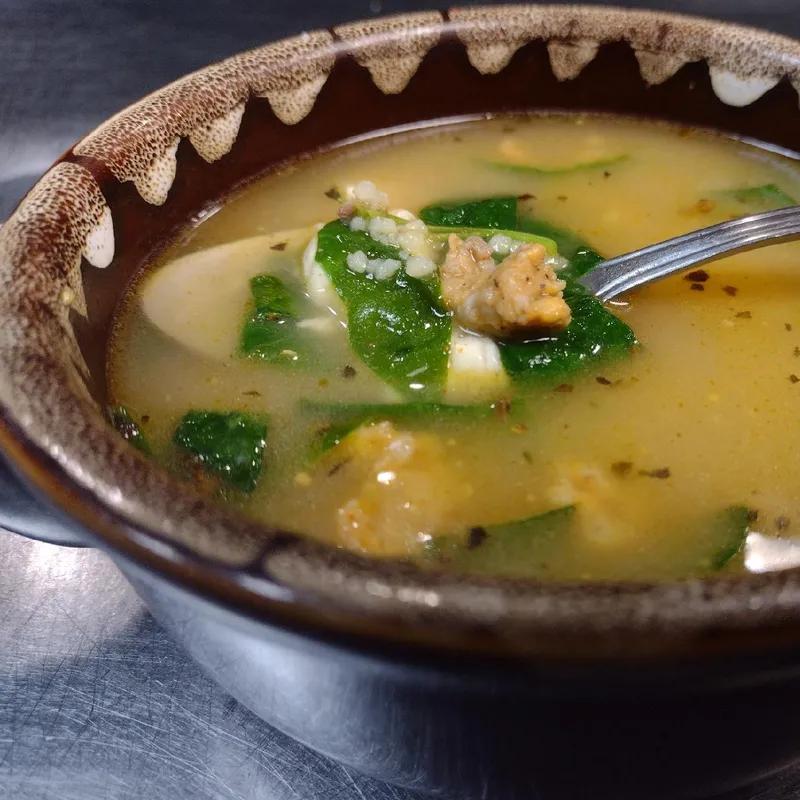 Bowl of soup topped with cheese